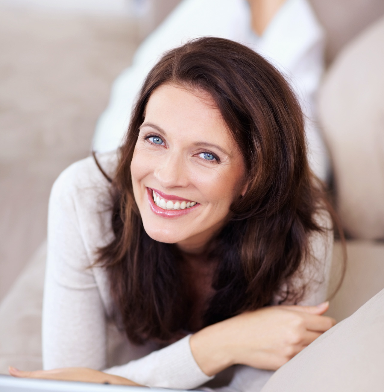 smiling brunette woman with blue eyes