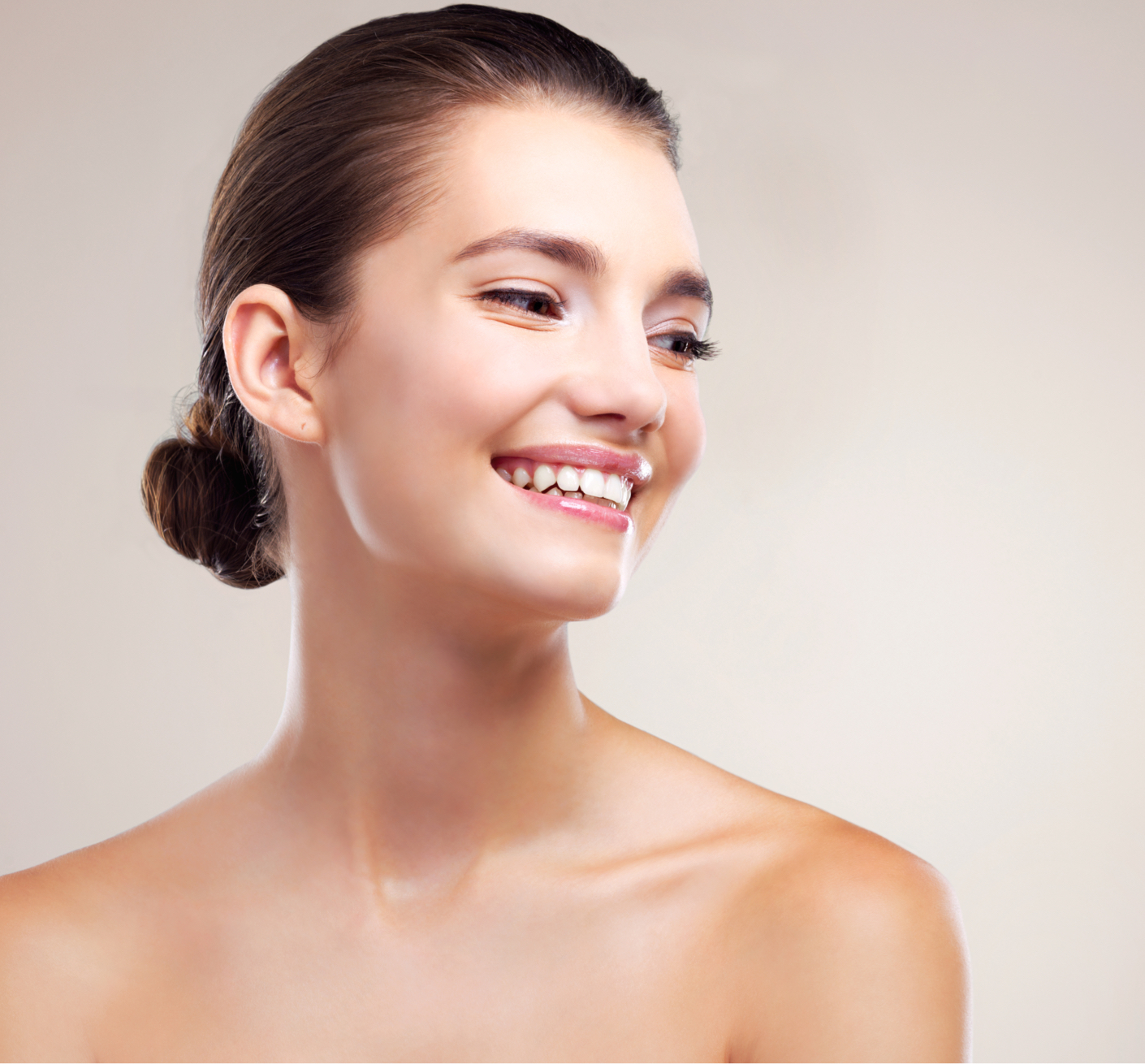 woman smiling with her hair in a bun